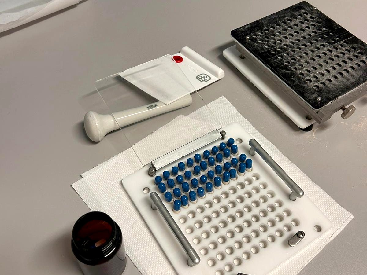 Fase di riempimento delle capsule nel laboratorio galenico di Amafarmacia Mortari